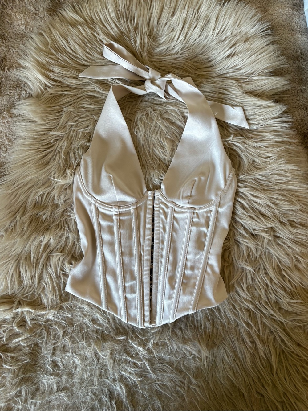 Cream corset top with tie back and bow detail